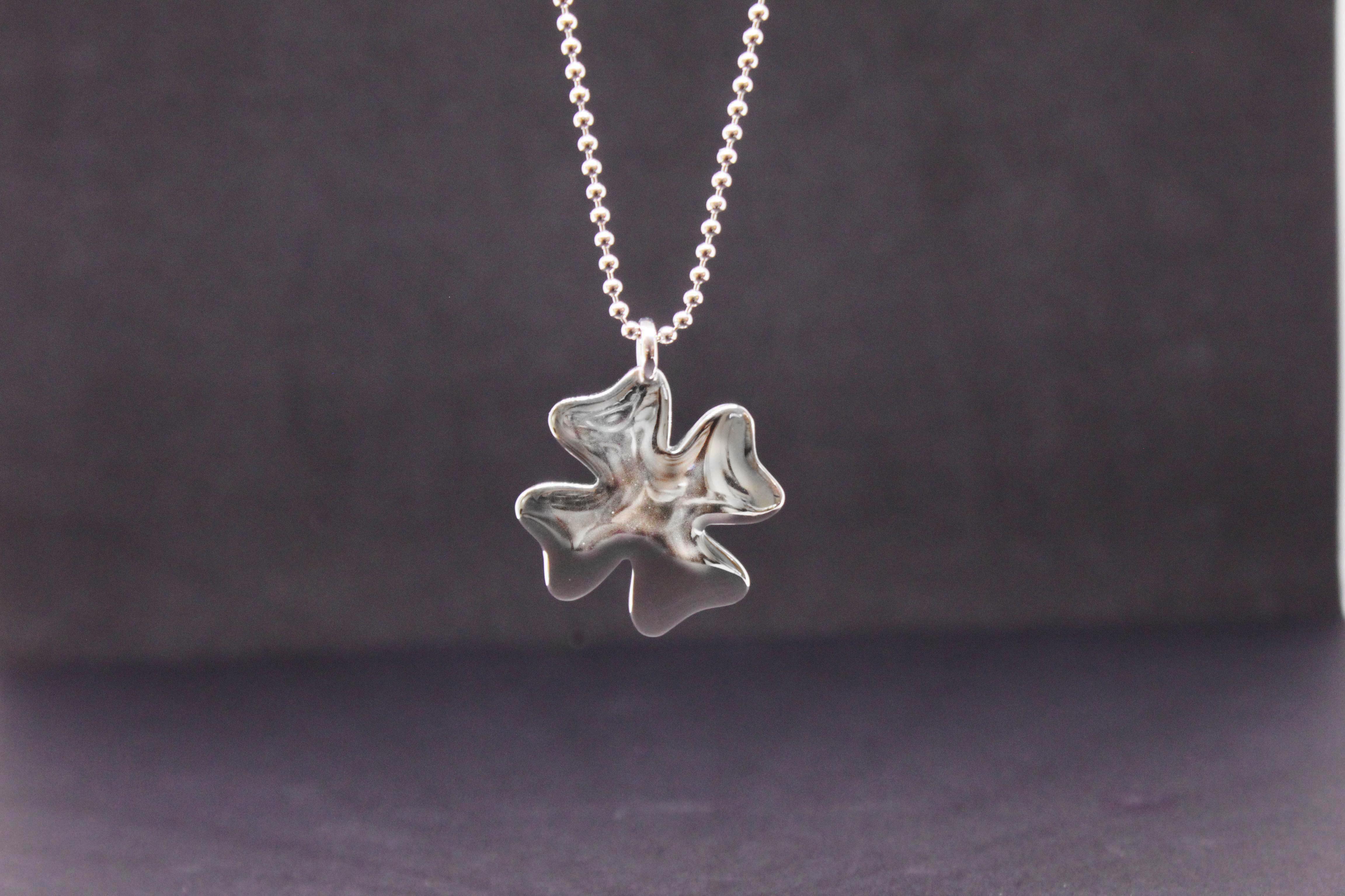 Silver four-leaf clover pendant with long necklace