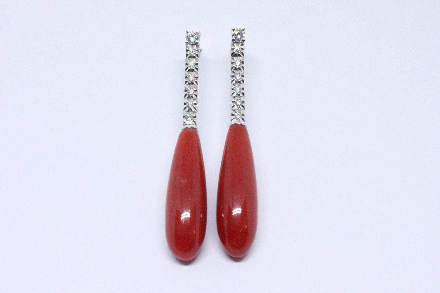White gold pendant earrings with diamonds and coral drop-shapped
